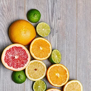 Top view of citrus fruits on white wooden table