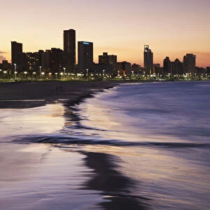 View of city skyline and beachfront at sunset, Durban, KwaZulu-Natal, South Africa