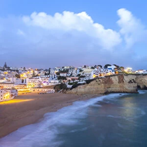 View of the lights of the village of Carvoeiro and its beach at blue hour