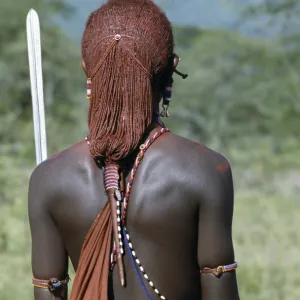 A back view of a Msai warrior resplendent with long