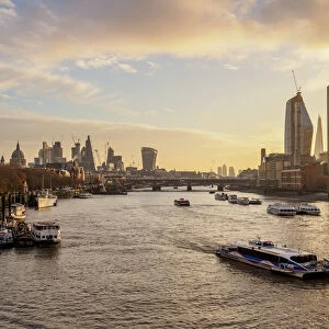 View over River Thames towards Southwark and City of London at sunrise, London, England