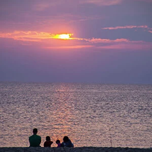 Visitors gather at Sunset Beach to watch the sunset