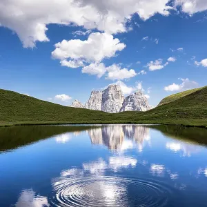 Water circles at Lago delle Baste with Monte Pelmo in the background. Altipiano of Mondeval, Giau pass, Cadore, Belluno province, Veneto, Italy Water circles at Lago delle Baste with Monte Pelmo in the background. Altipiano of Mondeval, Giau pass, Cadore, Belluno province, Veneto, Italy