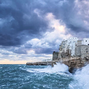 Waves crash on the cliff during a winter storm. Polignano a Mare, Apulia, Italy