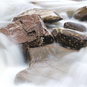 Detail of wet rocks in flowing River Etive stream, Glen coe, Highland Region, Scotland