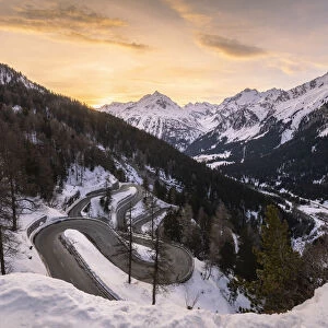 The winding curves of Maloja Pass road in winter at sunset, Bregaglia Valley, canton of Graubunden, Engadin, Switzerland