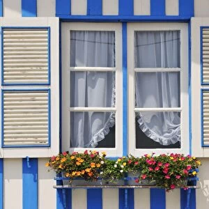 Window of a traditional striped painted house in the little seaside village of Costa Nova