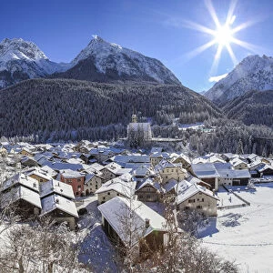 Winter at Scoul village at Engadine, in the background the Lichana peak, Switzerland