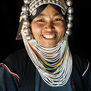 A woman from Akha tribal village wearing traditional headdress made of heavy silver