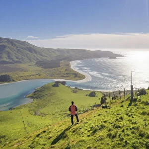 A woman enjoying the view of Hoopers inglet and the coastline near Dunedin in the Otago