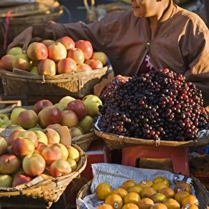 A woman sells a delicious selection of fresh fruit at Sittwes bustling market