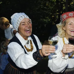 Woman in Traditional Dress enjoying Food and Wine at