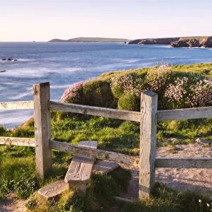 Wooden stile on Cornish clifftops near Porthcothan Bay with views to Trevose Head
