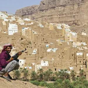 Yemen, Hadhramaut, Wadi Do an, Ribat Ba-Ashan. A happy Yemeni man holds his AK-47