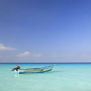 Yemen, Socotra, Sha ab. A boat moored in the sea at Sha ab