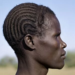 A young Turkana man with a braided hairstyle