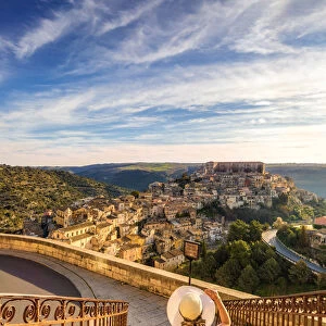 Young woman admiring the enchanting hilltop city of Ragusa Ibla from the stairs of Santa