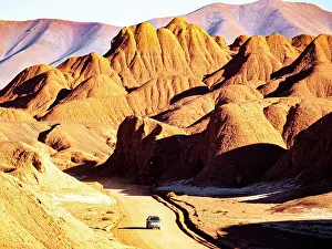 Pickup Prints: 4x4 on a road through red rock formations, Labyrinth desert, Puna, Salta, Argentina