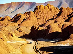 Pickup Prints: 4x4 on a road through red rock formations, Labyrinth desert, Puna, Salta, Argentina