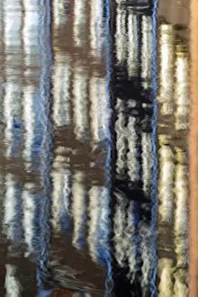 Abstract details of buildings reflected in a typical canal of the river Amstel Amsterdam
