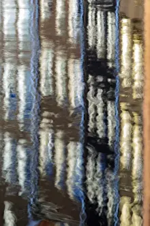 Abstract details of buildings reflected in a typical canal of the river Amstel Amsterdam