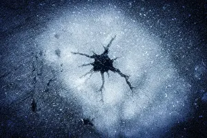 Circle Prints: Abstract ice shapes on cracked surface of a frozen lake in winter