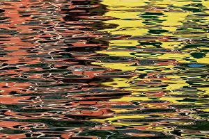 Abstract take on the reflection created by the colorful houses in Vernazza, Cinque Terre, during a spring sunset. Cinque Terre, Italy