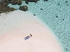 Aerial drone view of adult couple on a sandy beach, Maldives (MR)