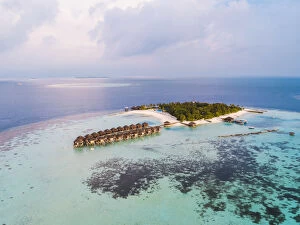 Aerial drone view of a tropical island at sunset, Maldives