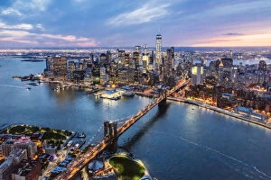 Earth from Above Gallery: Aerial of lower Manhattan skyline and Brooklyn bridge at dusk, New York, USA