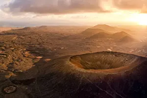 Light Natural Phenomenon Prints: Aerial panoramic of Calderon Hondo volcanic crater at sunrise, Corralejo, Fuerteventura