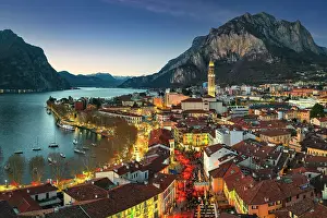 Rooftop Prints: Aerial panoramic of Christmas fairy lights and markets in the old alleys of Lecco old town at dusk