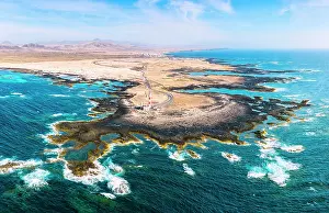 Rippled Prints: Aerial panoramic of El Toston lighthouse on cliffs washed by waves