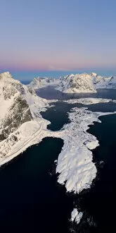 Aerial panoramic of Reine covered with snow at sunrise, Nordland, Lofoten Islands, Norway