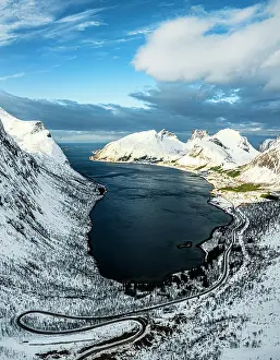 Winding Road Prints: Aerial panoramic of a snowy coastal road running to a fjord from Bergsbotn
