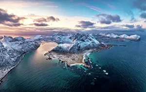 Finish Prints: Aerial panoramic view of Flakstad beach surrounded by snowcapped mountains and cold arctic sea