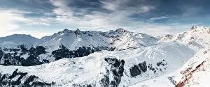 Madesimo Prints: Aerial panoramic view of mountain range covered with snow at sunset