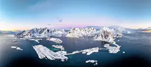 Frozen Water Prints: Aerial panoramic view of snowcapped mountains and Reine Bay facing the icy sea in winter