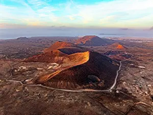 Environment Prints: Aerial panoramic view of volcanoes in the barren landscape at sunset
