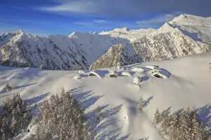 Valchiavenna Prints: Aerial photograph of Alpe Scima with the snowy peaks of Val Mesolcina that surround it