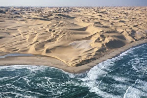 Namib Desert Gallery: Aerial shot of the cold waters of the Atlantic Ocean meeting the sand dunes of the