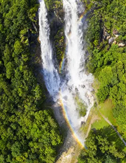 Aerial view of Acquafraggia Waterfall in spring with a rainbow. Valchiavenna, Valtellina