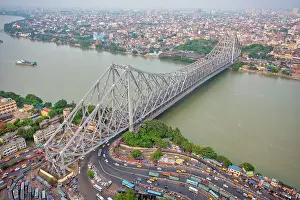 Highway Prints: Aerial view of architectural landmark Howrah bridge or Rabindra Setu over the Hooghly River at day in Kolkata