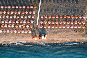 Gargano Prints: Aerial view of beach umbrellas in a row on sand beach washed by waves, Vieste