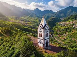 Aerial view of Capelinha de Nossa Senhora de Fatima surrounded by terraced fields at sunrise, Sao Vicente, Madeira, Portugal