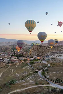 Kapadokya Prints: Aerial view of Cavusin and hot air balloons at dawn