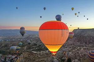 Kapadokya Prints: Aerial view of Cavusin and hot air balloons at dawn
