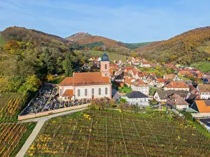 Grand Est Prints: Aerial view at the church of Orschwiller with the Chateau du Haut-Konigsbourg