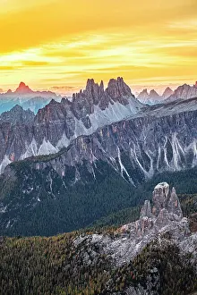 Environment Prints: Aerial view of Cinque Torri and Cima Ambrizzola mountain peaks under a fiery sky at dawn in autumn