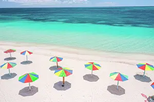 West Indies Prints: Aerial view of colorful beach umbrellas of a tourist resort on a beach washed by Caribbean Sea